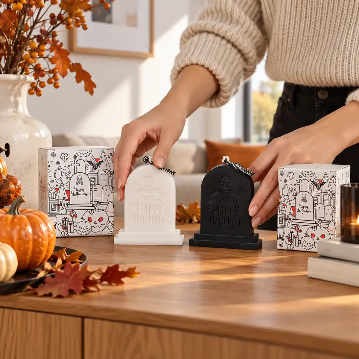 Hände arrangieren Halloween Duftkerzen in Grabsteinform
