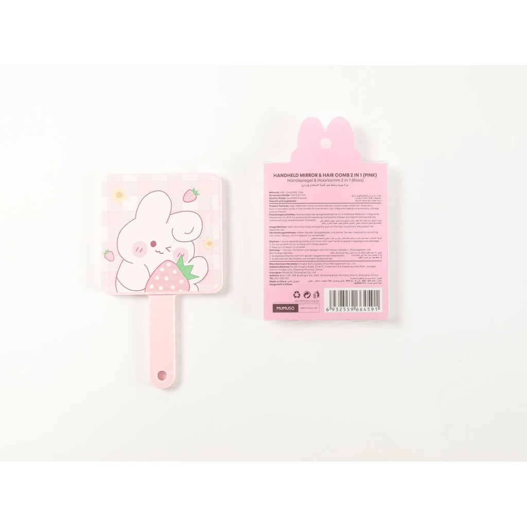 Rosa Handspiegel mit Kamm und Verpackung auf weißem Hintergrund