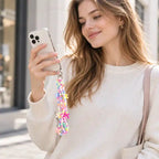 Frau hält ein Smartphone mit bunter Sweet Dream Perlen Handykette